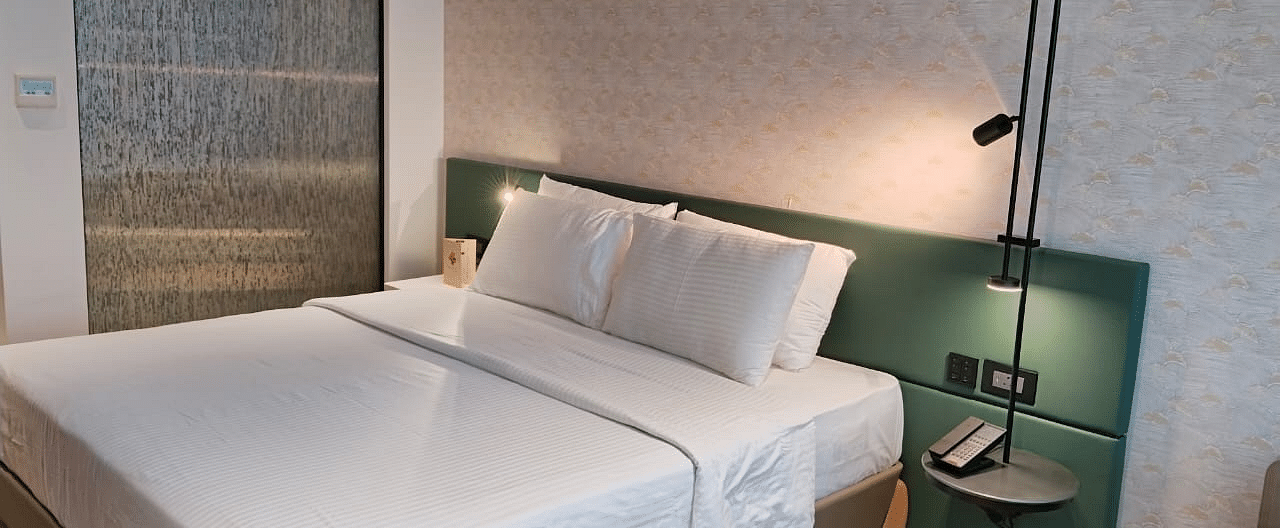 A king size bed in the Deluxe Room at Regency Hotel, Mumbai.