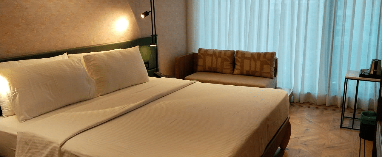 A king size bed in the Deluxe Room at Regency Hotel, Mumbai.
