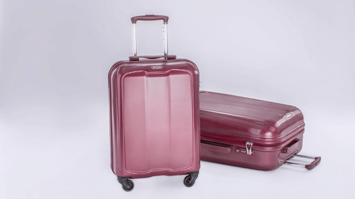 A set of two suitcases, one upright and one lying flat, at the best resort in Bangalore.