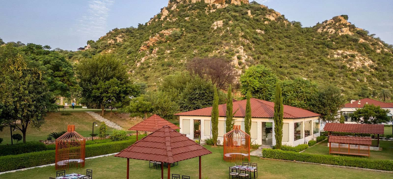 Top view of an open-air dining space at Valley by Grassfield, set against a stunning mountain backdrop.