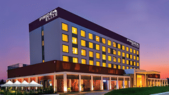 A facade image of the Pride Elite Phaltan with a dusky sky in the background