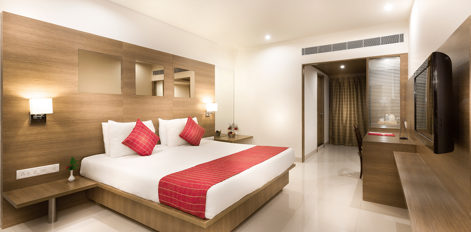 An image of a king size bed of a Deluxe Room at Regency Tiruttani by GRT Hotels.