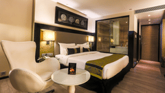 The Empresa Boutique Hotel - the king size and a sitting space beside it in the Executive Room in Andheri