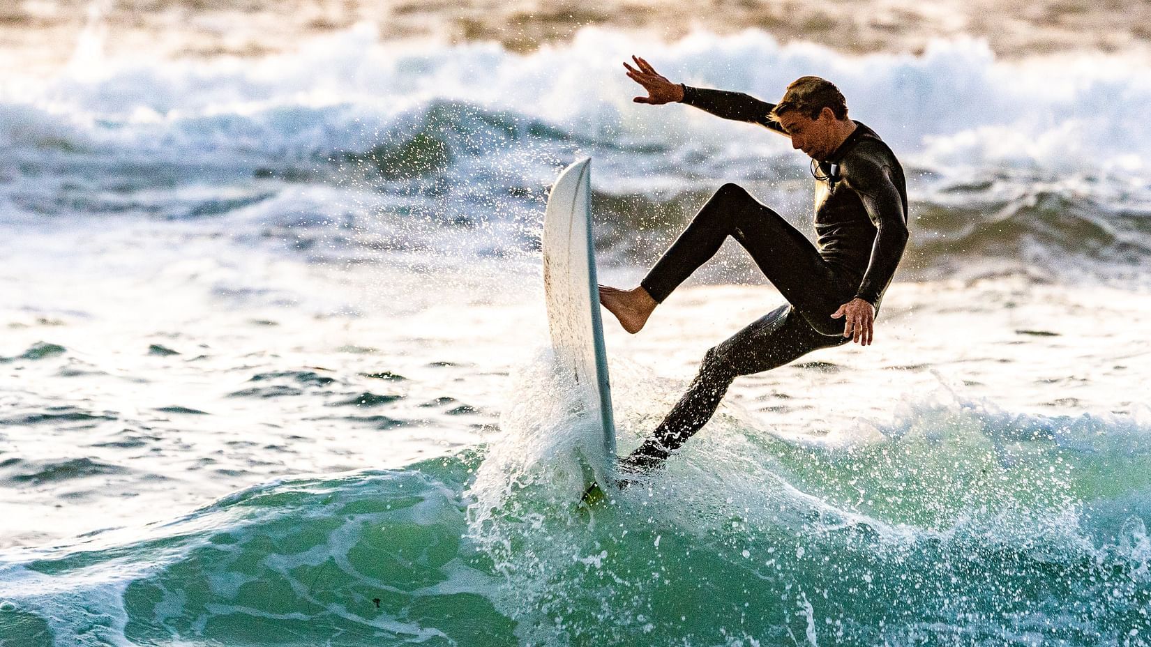 A man surfing in blue waters