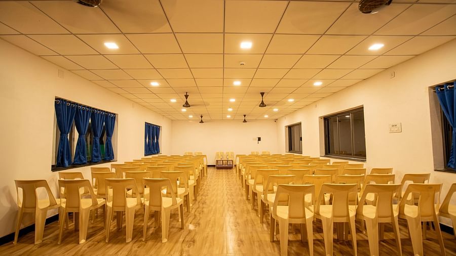 A well-lit event hall with neatly arranged rows of chairs, ready for an upcoming event or conference - VITS Select Diamond Resort, Sasan Gir