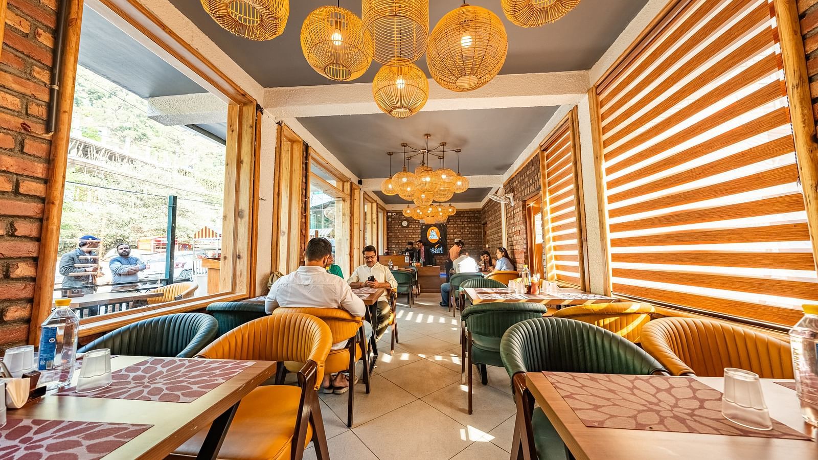 Front view of the Kesari Restaurant with cosy interiors with several customers seated in the dining setup.