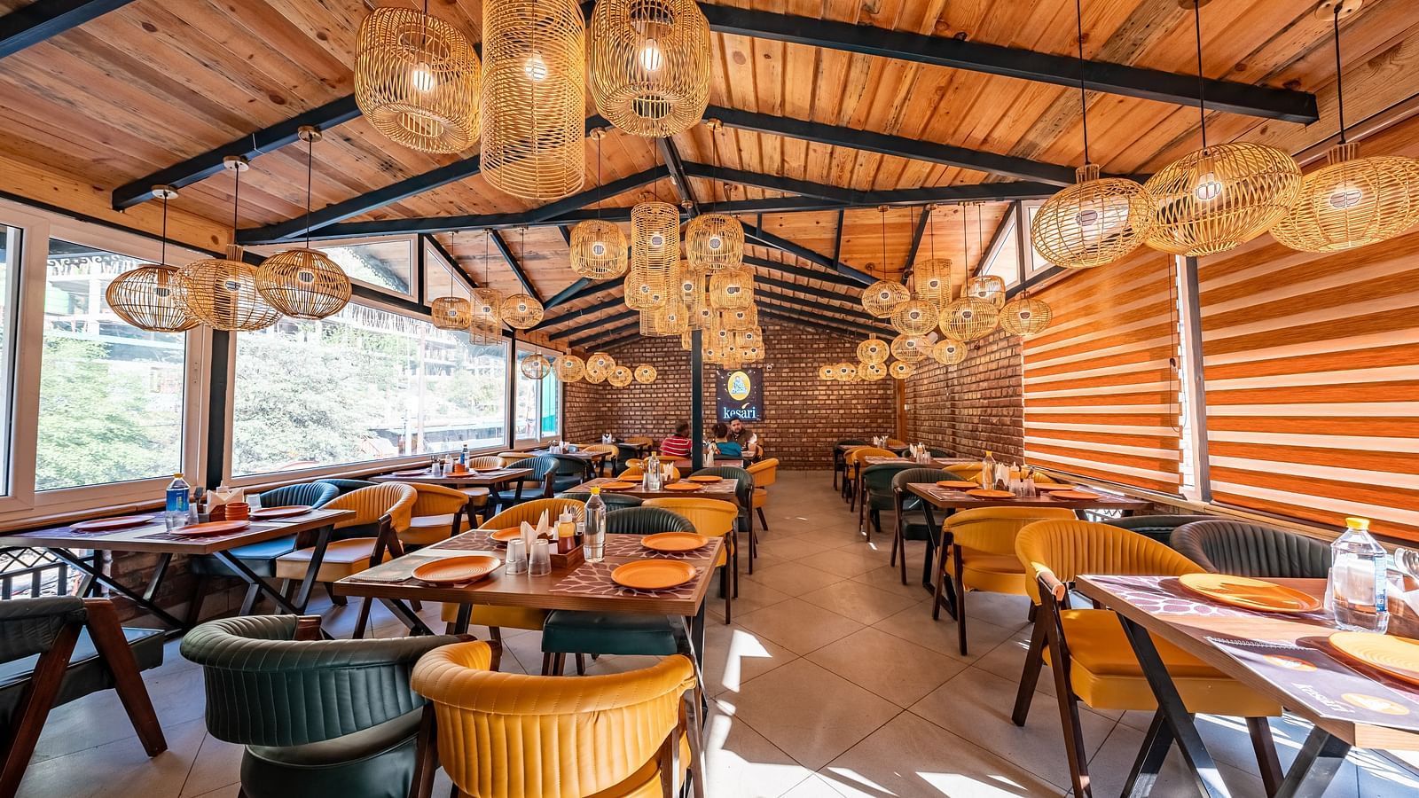 Full view shot of the Kesari Restaurant with ample of bright natural light coming from the windows.
