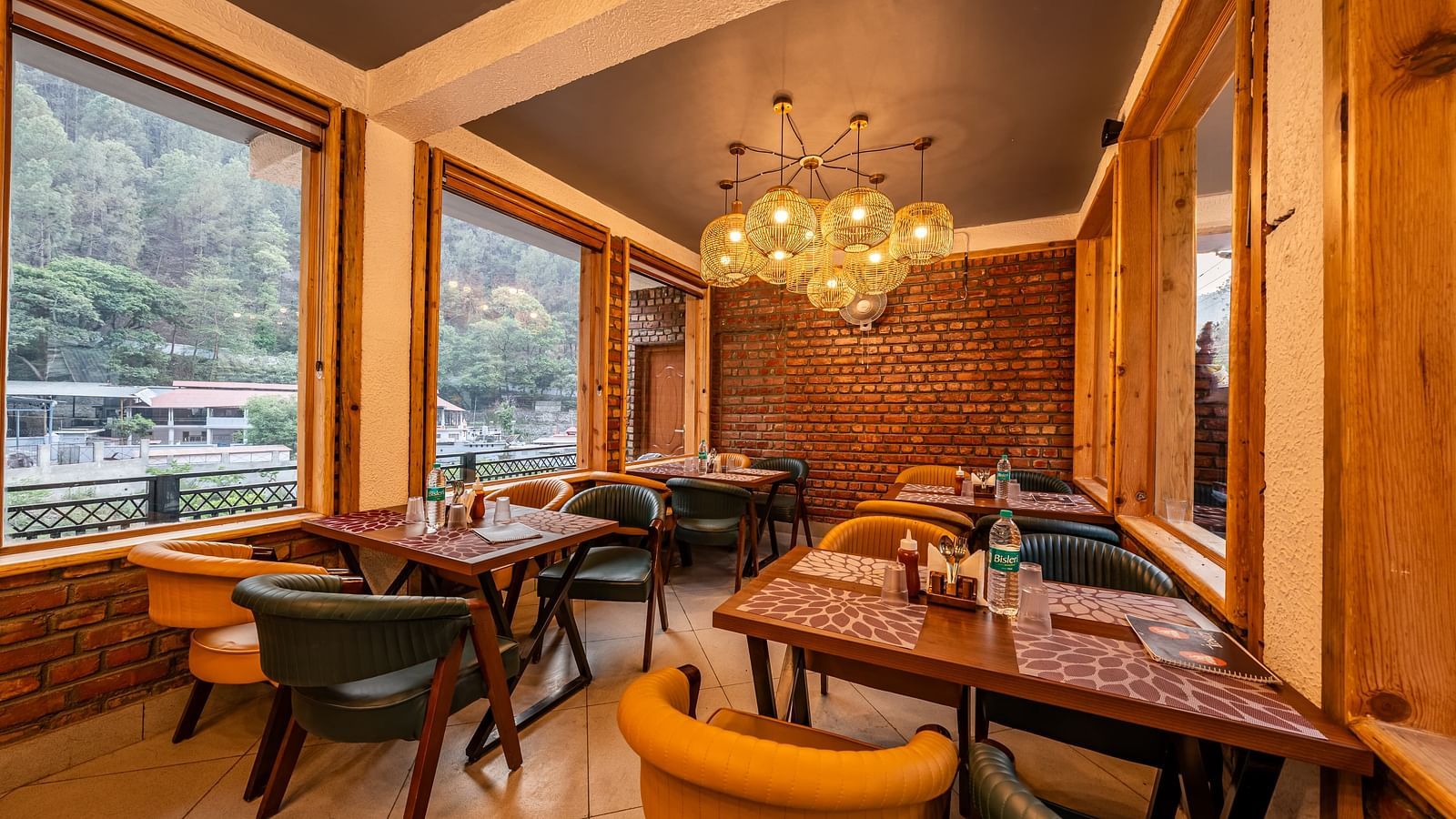 Corner view of the Kesari Restaurant by JVR Stays featuring a chandelier hanging from the ceiling.