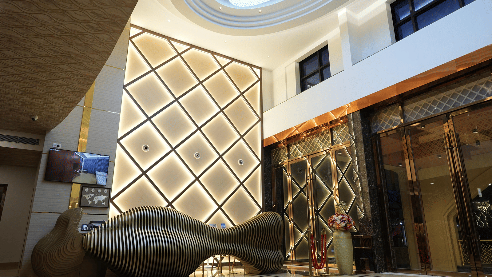 The lobby of Le Royale Palace with elegant decor, ambient lighting, and glass doors