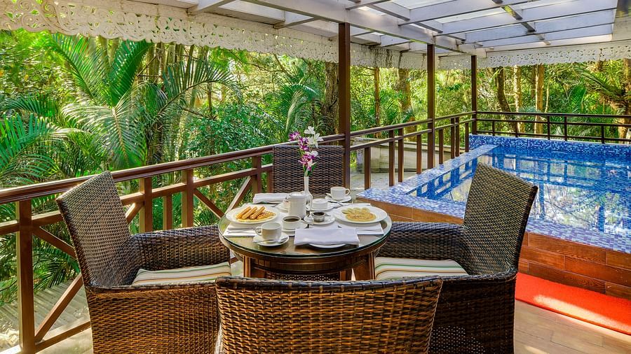 the outside dining seating space by a private pool attached with a room - Mayfair Spa Resort & Casino Gangtok 