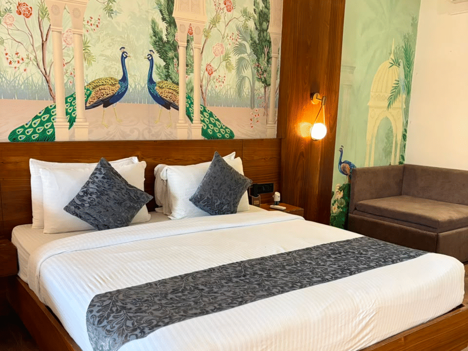 Skyline by Miraya, Emperor Suite, Hand-painted peacock mural behind the bed