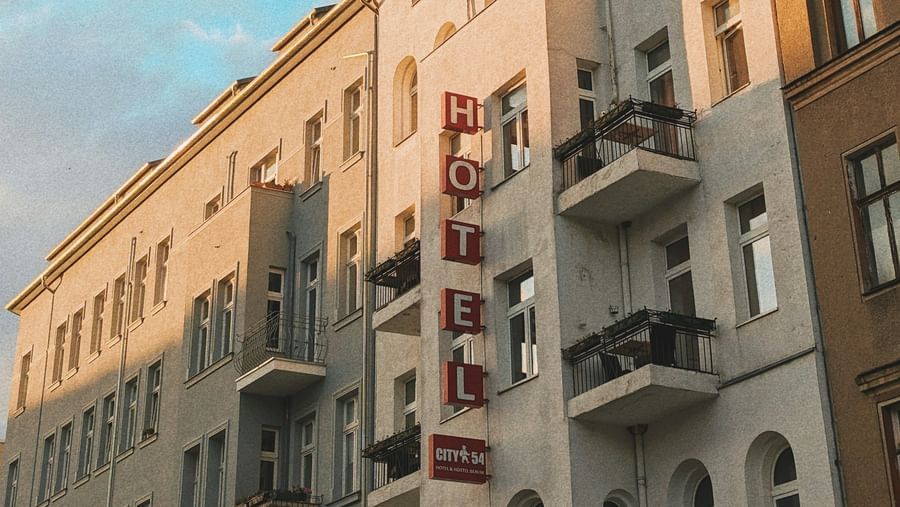  A low-angle view of a row of European-style buildings with balconies under a blue sky