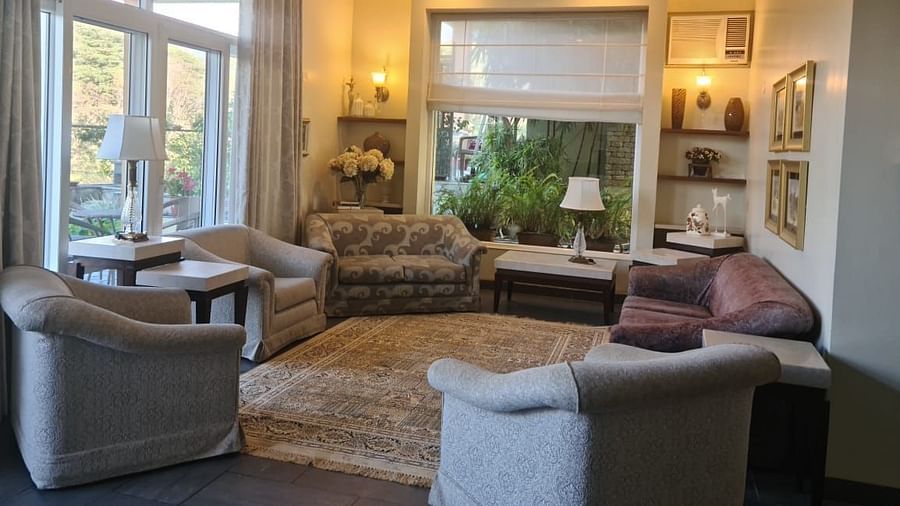 closer ciew of living room couch and interior decor with wide windows captured during day time - Lamrin Norwood Green Palampur1