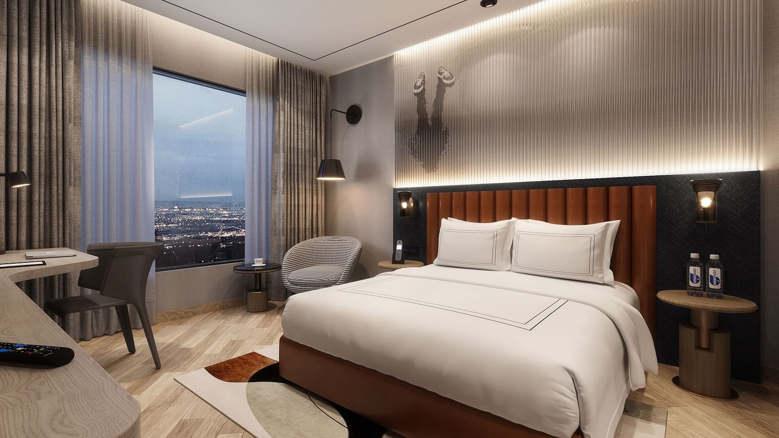 View of a hotel room with a made bed, desk, chair, and a large window showing a city view.