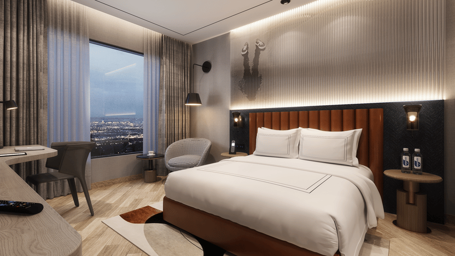View of a hotel room in Chandigarh with a made bed, desk, chair, and a large window showing a city view at Ramada Encore by Wyndham.