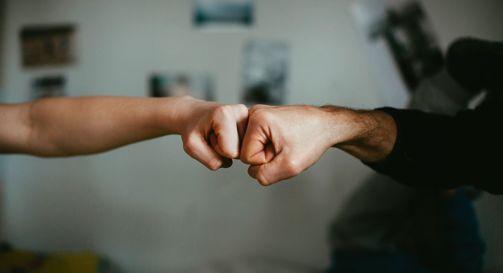 two people fist-bumping one another