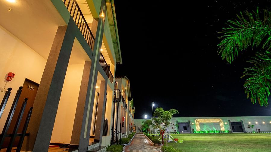 A close-up view of the resort’s pathway leading to the building, beautifully lit with modern lighting for an inviting atmosphere at night - VITS Select Diamond Resort, Sasan Gir