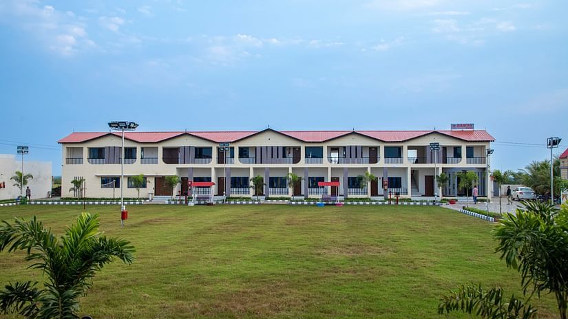A wide shot of the resort building surrounded by a lush green lawn, showcasing the spacious and serene environment - VITS Select Diamond Resort, Sasan Gir