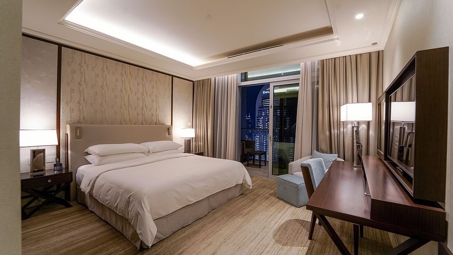 Address Fountain Views Residence Tower - the king size bed facing the TV in the bedroom attached to a balcony