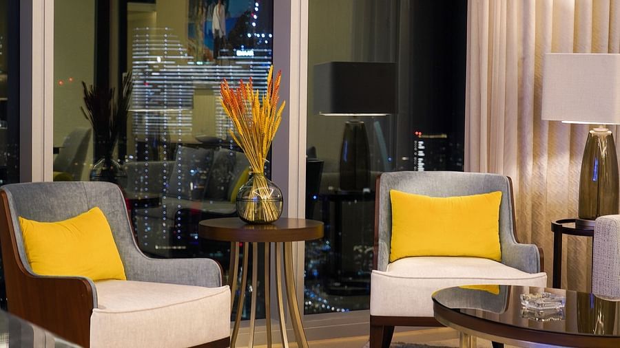 Address Fountain Views Residence Tower - two single sofas with yellow pillows kept by the window