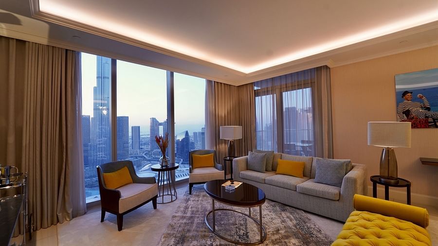 Address Fountain Views Residence Tower - the living room with grey sofa sets and yellow cushions kept on top of it 1