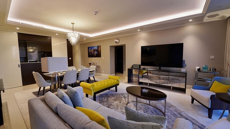 Address Fountain Views Residence Tower - the living room with grey sofa sets and yellow cushions kept on top of it
