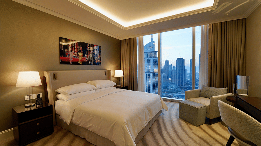 Address Fountain Views Residence Tower - the king size bed kept beside the window that overlooks Burj Khalifa during daytime