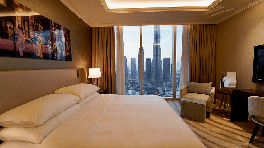 Address Fountain Views Residence Tower - the king size bed kept beside the window that overlooks Burj Khalifa during daytime 1
