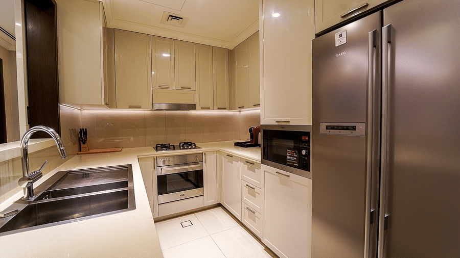 Address Fountain Views Residence Tower - the kitchen area offering a fridge, a sink, a microwave and shelfs