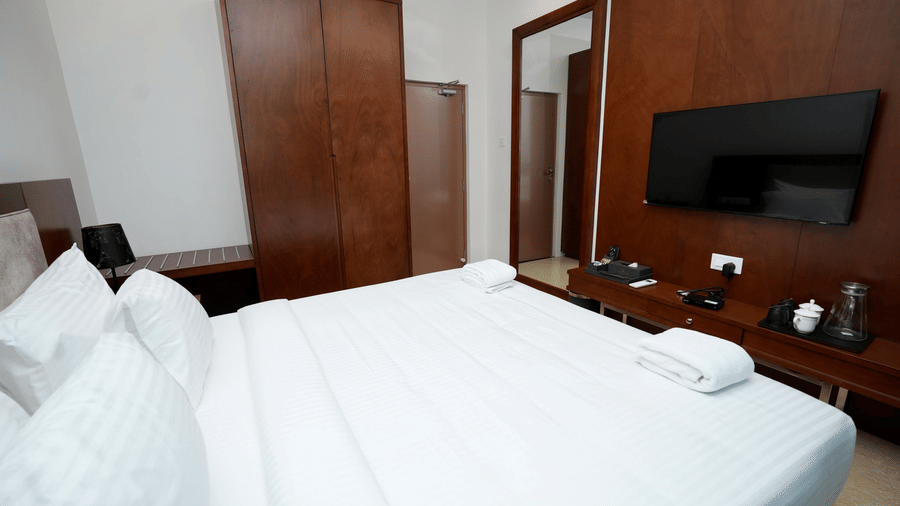 A Family Suite at Le Royale Palace with a large bed, flat-screen television, and wardrobe creating a modern stay ambiance