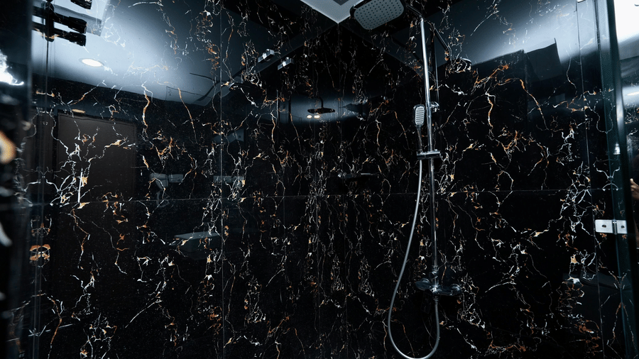 A shower area with elegant marble-patterned walls in Le Royale Palace Standard Family Deluxe Room