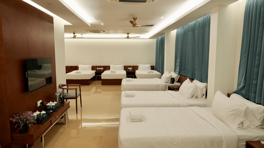 A sleek bathroom in the Superior Family Room at Le Royale Palace with dark marble walls and premium fittings