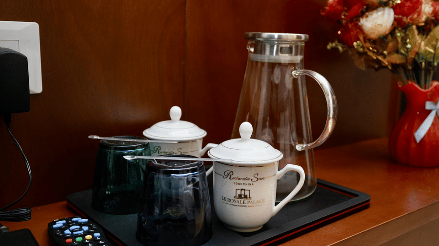 A refreshment setup in the Superior Family Room at Le Royale Palace with tea cups, glassware, and a water jug placed neatly on a tray
