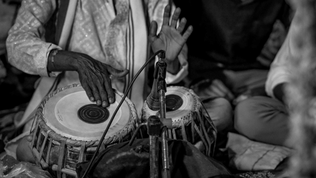 A man playing tabla, a traditional Indian musical instrument.