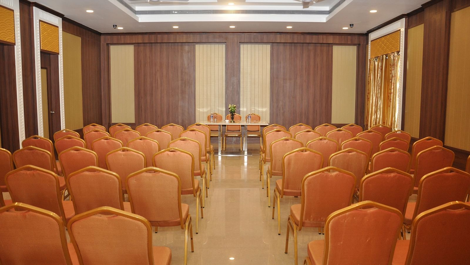 event halls with red chairs at Hotel Alps Residency, Krishnagiri