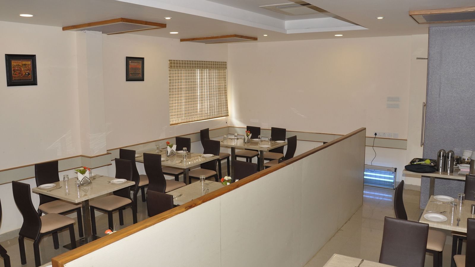 interior dining setting of a restaurant at Hotel Alps Residency, Krishnagiri