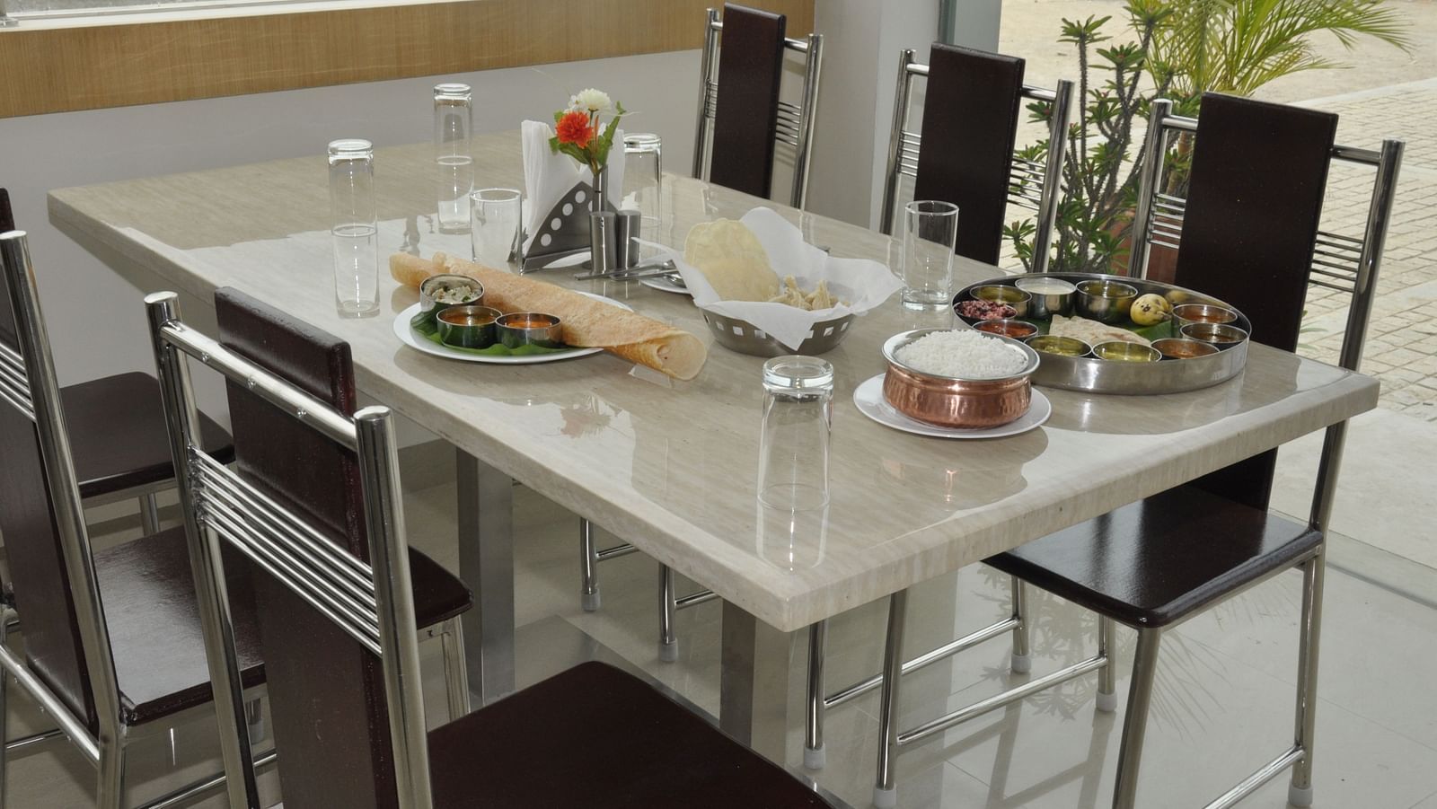 interior dining setting of a restaurant at Hotel Alps Residency, Krishnagiri