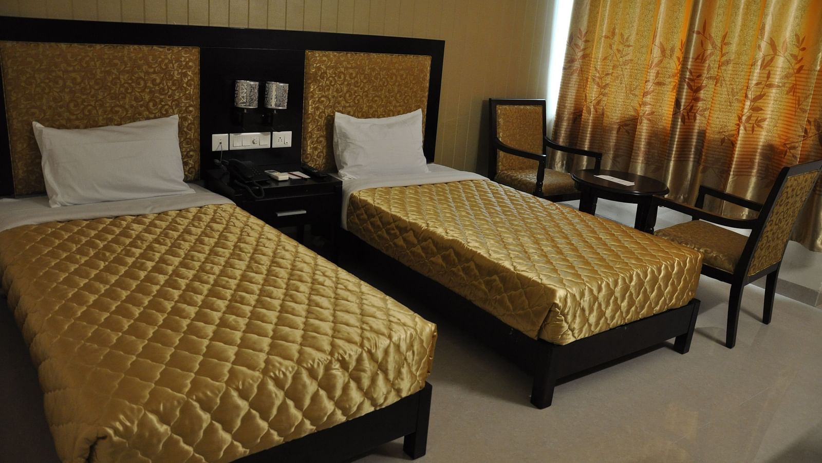 view of a twin beds of a room at Hotel Alps Residency, Krishnagiri