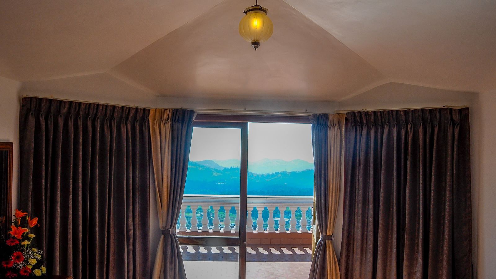 a view of the green valley of Ooty from the room at La Montana By TGI