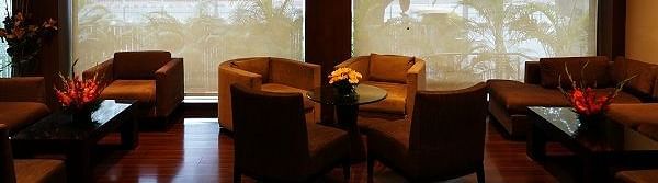 sofa arranged against a large window at Shervani Nehru Place, New Delhi