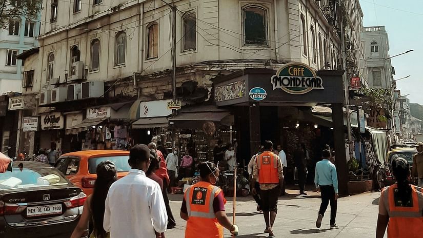 image featuring a building on a bright sunny day at the colaba causeway with people roaming around