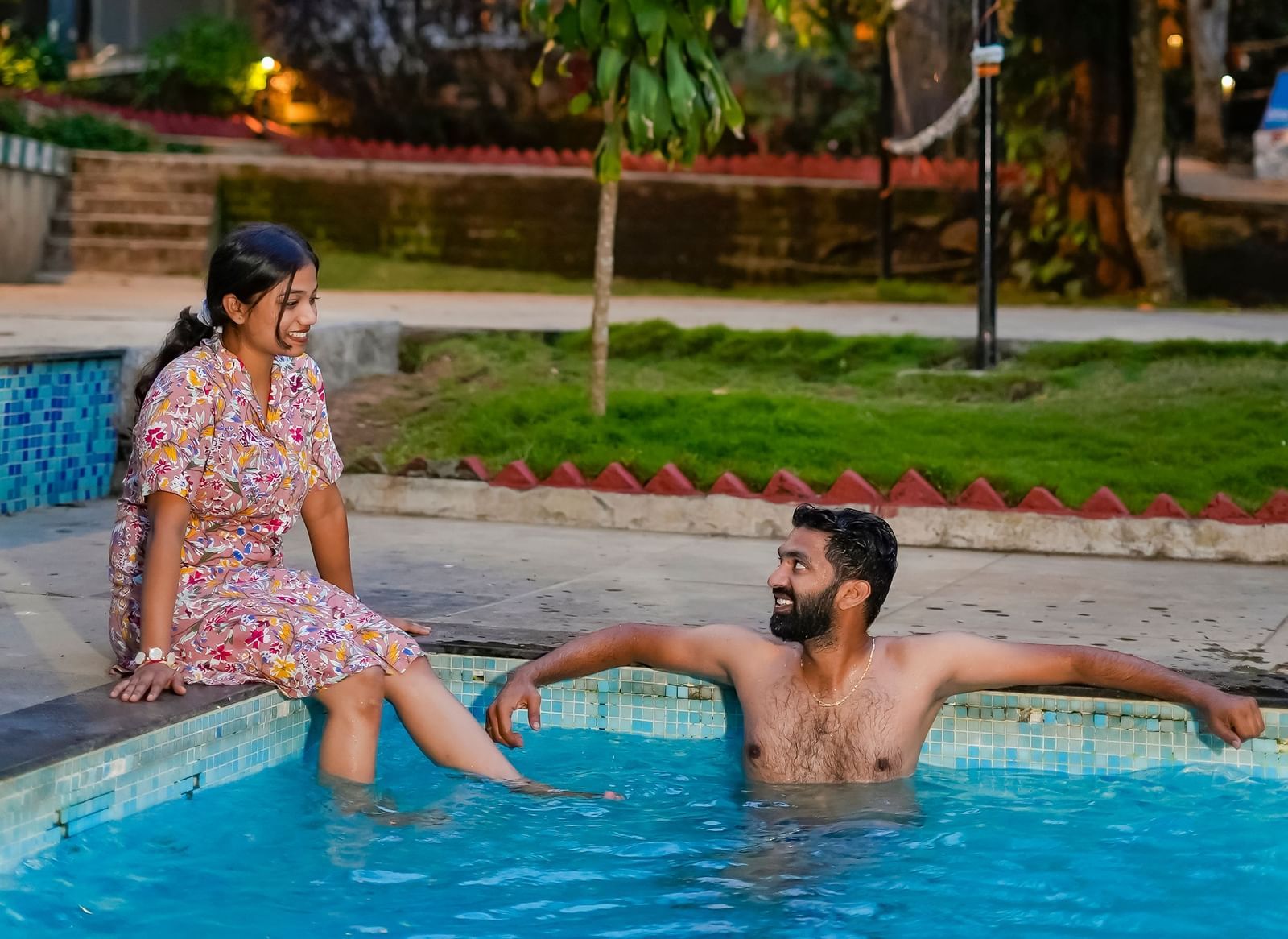 A man and woman relaxing in an outdoor swimming pool at WOW Bungalow, Yercaud.