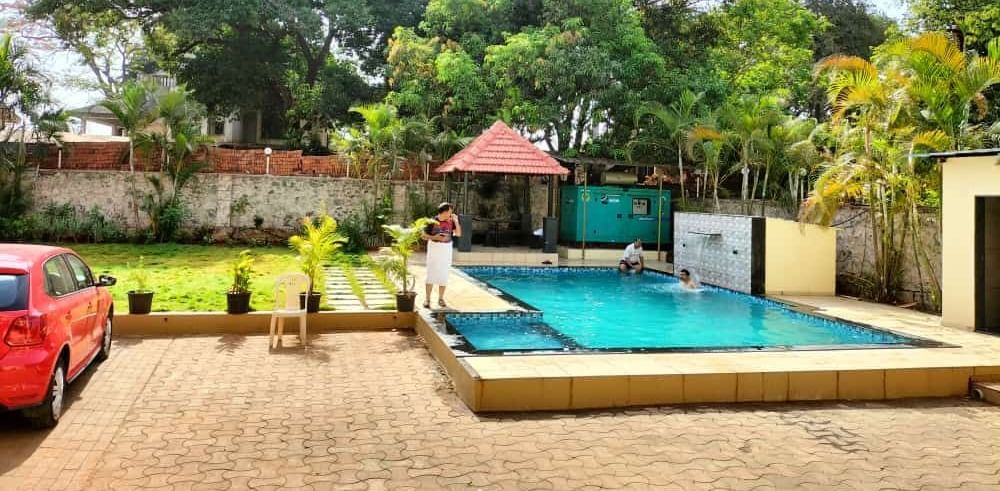 Clear outdoor swimming pool with gazebo at Mountview Resort, on a sunny day.