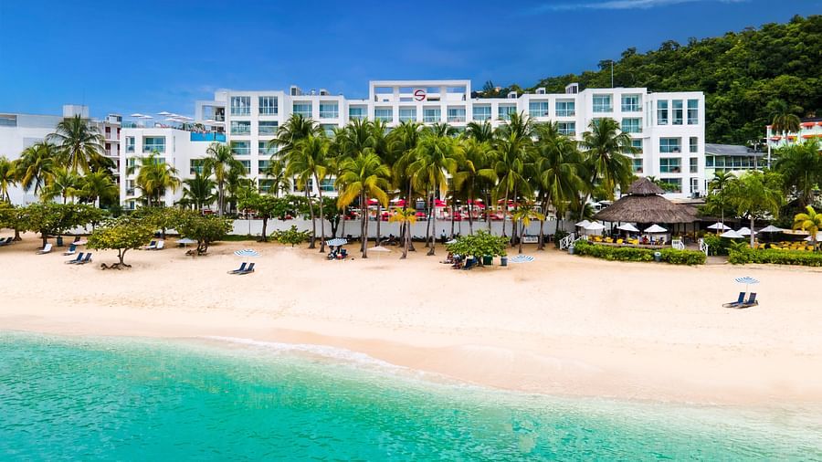 A wide-angle shot of our hotel with a beach in the fore ground - S Hotel Montego Bay, Jamaica
