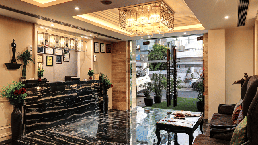 A view from the lobby looking toward the glass entrance doors, featuring a sleek check-in desk and modern interior decor - Flute Boutique By Hotel 91, Jaipur