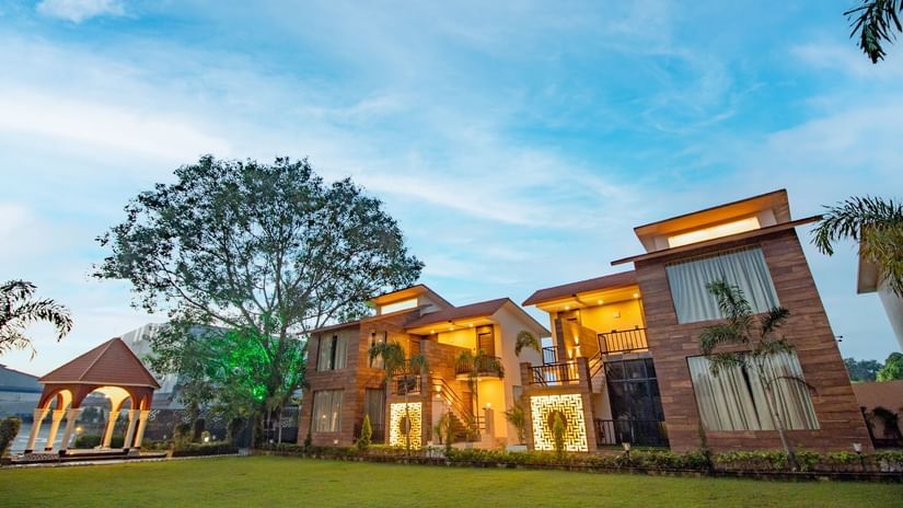 The facade of the villas set against the vivid blue sky - Wedlock Greens Hotel Resorts Dhanbad.