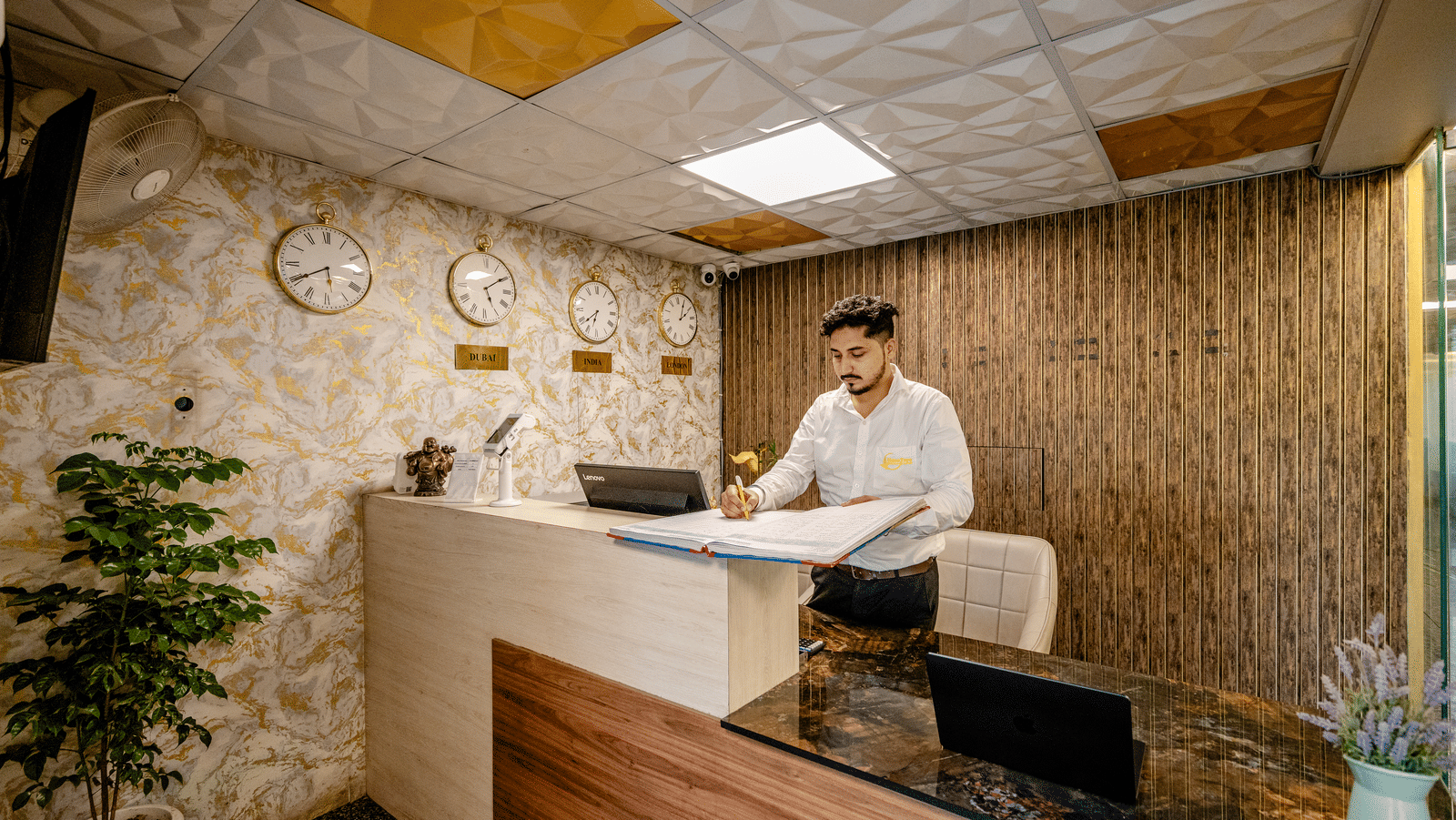 Reception lobby at Lime Tree Hotel Near Medanta-The Medicity, Gurgaon featuring a receptionist work behind the desk.