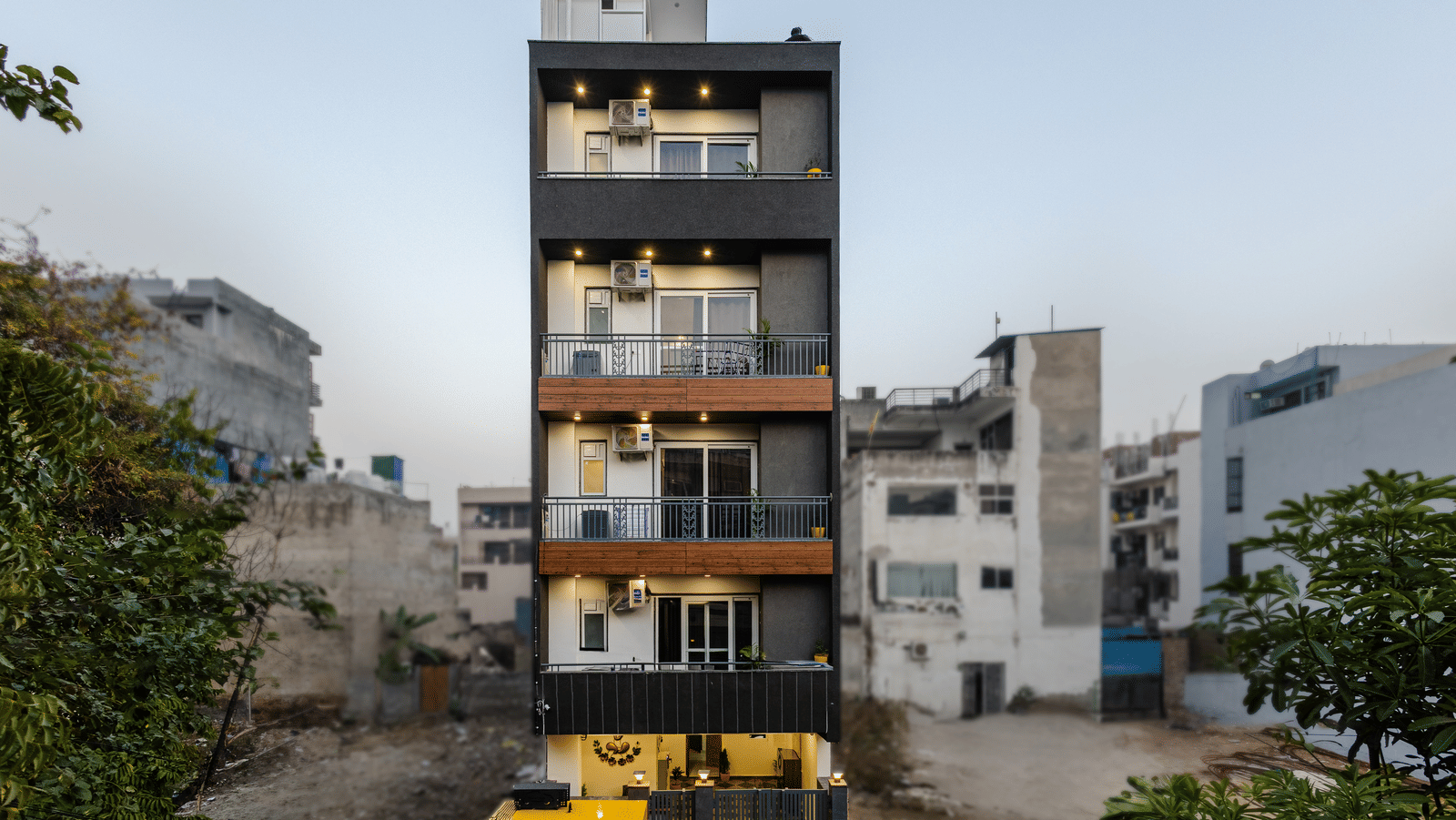 Multiple storey building exterior of Lime Tree Hotels & Service Apartment Private Limited featuring a street side view and surrounding structures.