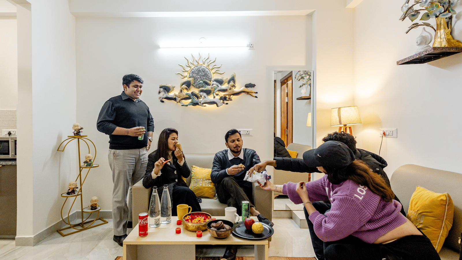 Guests seated around a dining table in a lounge area of Lime Tree Hotels & Service Apartment Private Limited.