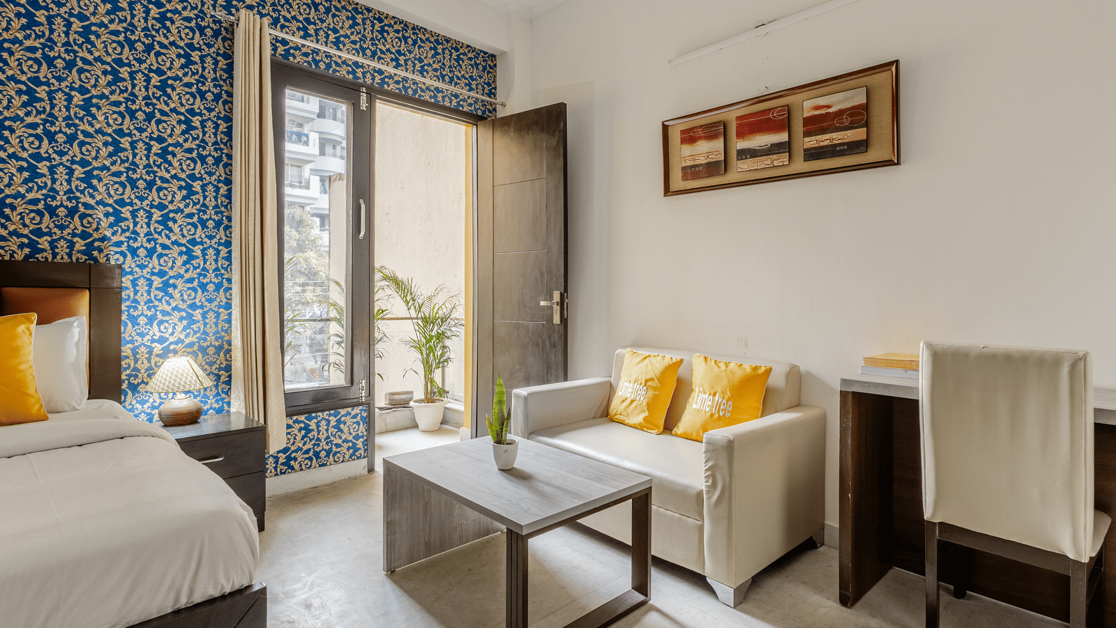 Room view with sofa and entry to balcony at Lime Tree